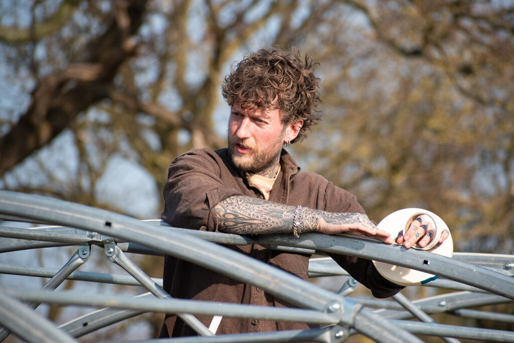 Jamie aka Nettles and Petals applying hot spot tape to his EasyBuild Polytunnel