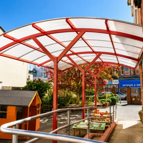 Bespoke covered walkway canopy providing sheltered outdoor space for a school playground