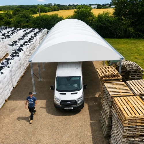 Bespoke commercial canopy providing covered vehicle access and weather-protected storage
