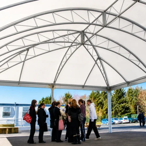 Large-span school canopy providing covered outdoor space for students during breaks and social activities