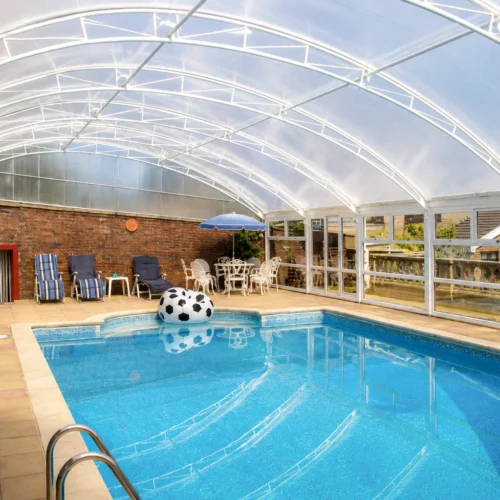 Bespoke swimming pool enclosure providing year-round weather protection and natural light