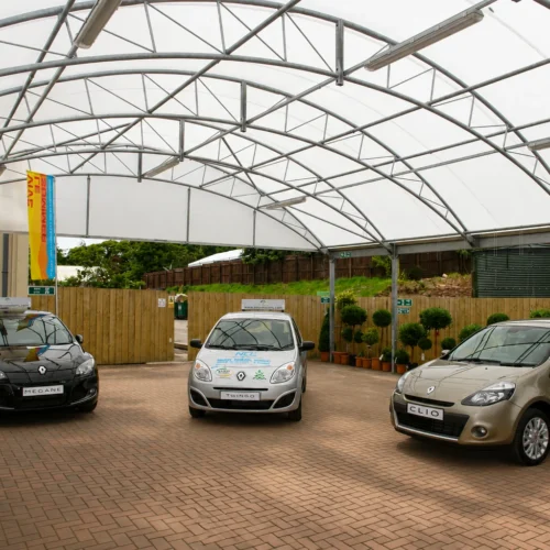 Large-span commercial canopy structure creating covered retail display space at a garden centre