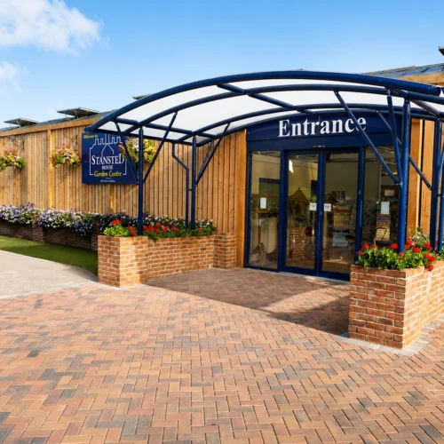 Steel-framed entrance canopy creating a welcoming covered entrance for garden centre visitors